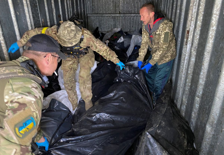Ukrainian servicemen and a ritual worker load bodies of killed Russian soldiers to a refrigerated rail car, as Russia's attack on Ukraine continues, at a compound of a morgue in Kharkiv, Ukraine May 22, 2022.