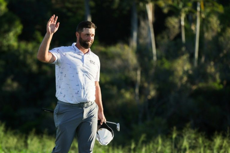 Jon Rahm acknowledges fans after putting to tie the course record and take share of the third-round lead in the PGA Tour Tournament of Champions