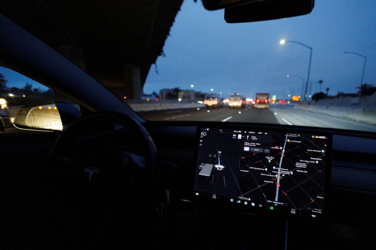 A Tesla Model 3 vehicle drives on autopilot along the 405 highway in Westminster, California, U.S., March 16, 2022. 