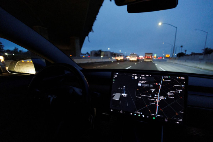 A Tesla Model 3 vehicle drives on autopilot along the 405 highway in Westminster, California, U.S., March 16, 2022.