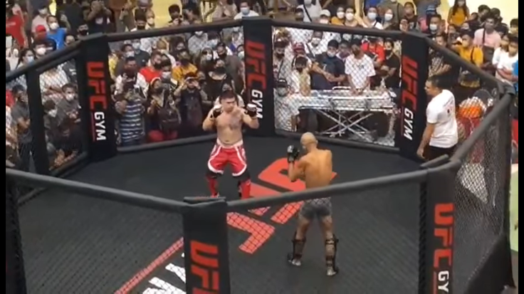 Reginaldo Cruz (bottom) squares off with his opponent at a local amateur event in the Philippines.