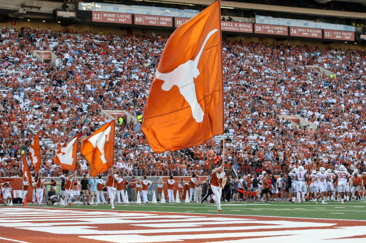 The Texas Longhorns cheerleaders run with flags after a touchdown during the Orange-White Spring Game at Darrell K Royal-Texas Memorial Stadium on April 23, 2022 in Austin, Texas.