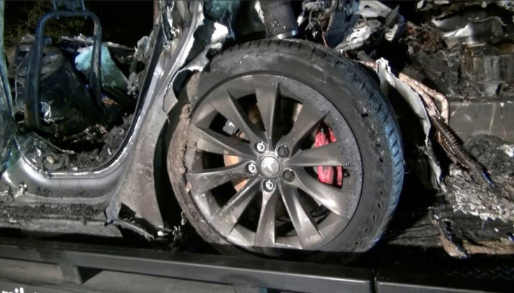 The remains of a Tesla vehicle are seen after it crashed in The Woodlands, Texas, April 17, 2021, in this still image from video obtained via social media. Video taken April 17, 2021. SCOTT J. ENGLE via