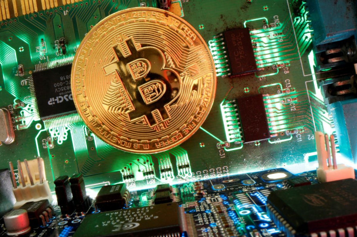 Representation of the virtual currency Bitcoin is seen on a motherboard in this picture illustration taken April 24, 2020.