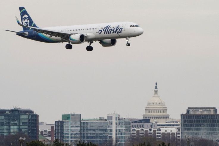 An Alaska Airlines aircraft flies past the U.S. Capitol before landing at Reagan National Airport in Arlington, Virginia, U.S., January 24, 2022.