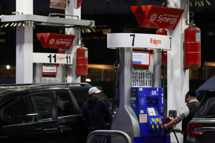 People pump gas at an Exxon gas station in Brooklyn, New York City, U.S., November 23, 2021.