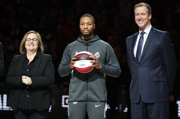 Damian Lillard #0 of the Portland Trail Blazers is honored for his NBA All Star selection by Portland Trail Blazers Owner Jody Allen and Head Coach Terry Stotts of the Portland Trail Blazers prior to taking on the Miami Heat at Moda Center on February 09,