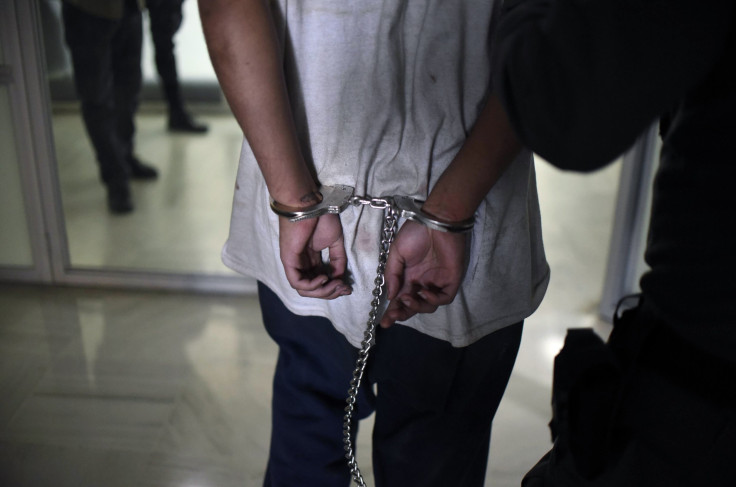 Romeo Xavier Langhorne reportedly trolled the FBI and other agencies on social media before he was arrested. In this photo, a handcuffed inmate of the Stage II Male Juvenile Detention Center, is escorted as he arrives for a hearing at a court in Guatemala