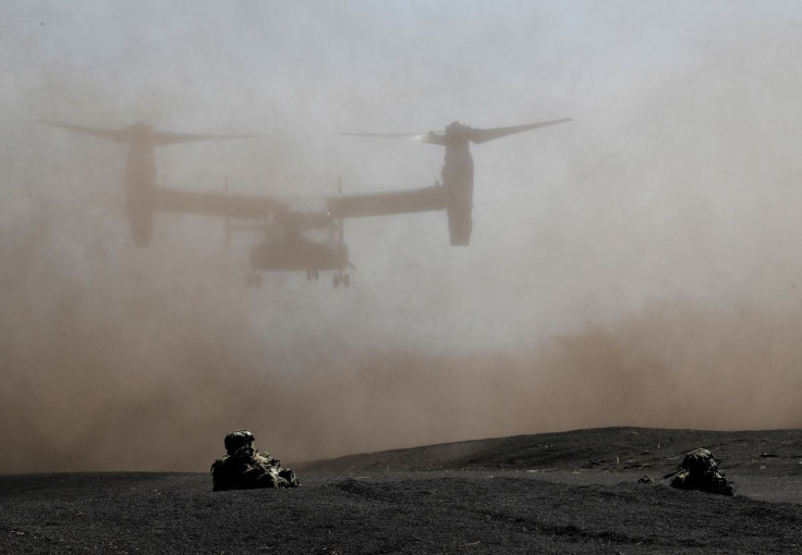 Members of the Japanese Self-Defense Forceâs Amphibious Rapid Deployment Brigade take positions while U.S. Marine Corps MV-22 Osprey lands during a joint airborne landing exercise with U.S. Marine Corps members at Higashifuji training field in Gotemba,