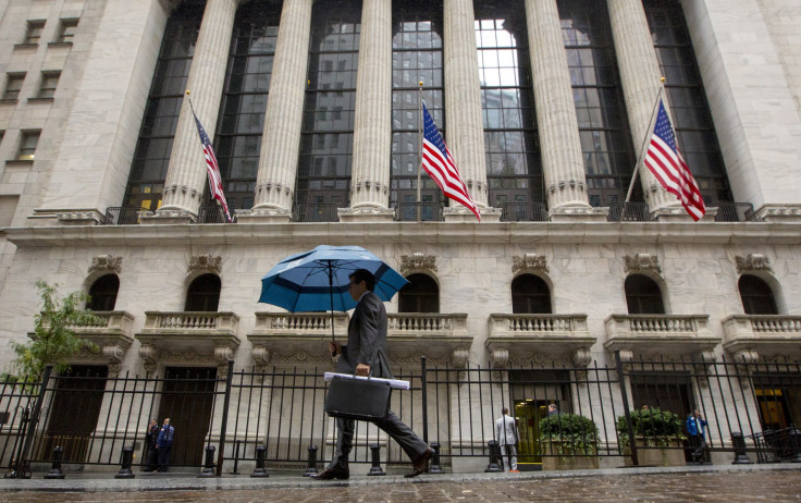 The tech sector led record gains in the S&P 500 index. Pictured: a man with umbrella walks past the New York Stock Exchange.