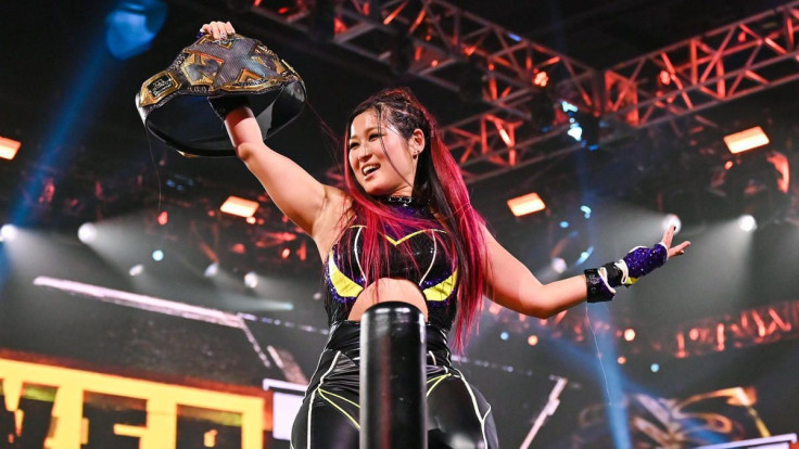 Io Shirai holds the NXT Women's Championship aloft after defeating Candice LeRae at NXT TakeOver 31 on October 4, 2020.