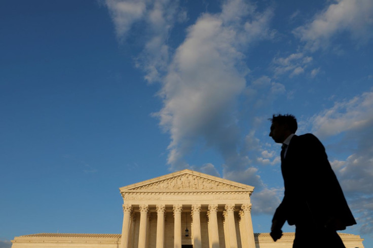 A person walks past the United States Supreme Court Building in Washington, D.C., U.S., May 13, 2021. 