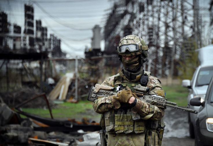  a Russian soldier stands guard at the Luhansk power plant in the town of Shchastya.