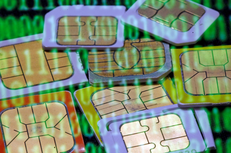 SIM cards are reflected on a monitor showing binary digits in this picture taken, Feb. 23, 2015.