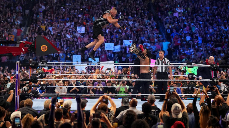 Brock Lesnar (left) leaps from a tractor onto Roman Reigns (right) during their main event match at SummerSlam on July 30, 2022.