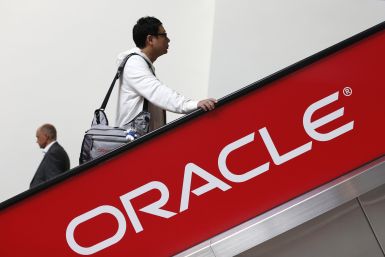 Oracle is reportedly planning to layoff thousands of employees. In photo: two attendees ride an escalator during Oracle OpenWorld 2012 in San Francisco, California October 1, 2012.