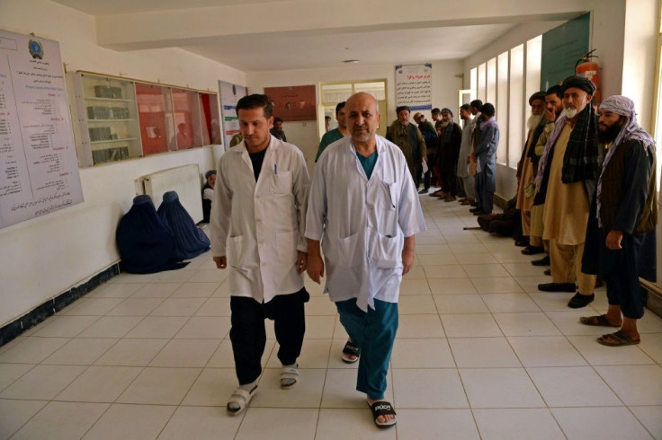 Doctors walk inside a regional hospital where victims of October 8 suicide bombing at the Gozar-e-Sayed mosque are being treated