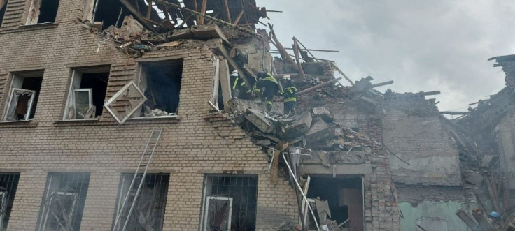 Rescuers work at a site of a school building destroyed by a Russian military strike, as Russia's attack on Ukraine continues, in the town of Mykolaivka, in Donetsk region, Ukraine, in this handout picture released August 2, 2022. Press service of the Sta