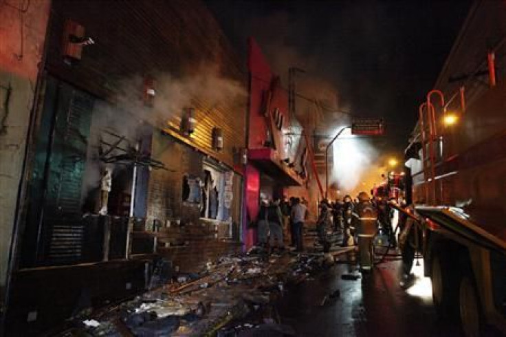 Fire-fighters try to extinguish a fire at Kiss nightclub.