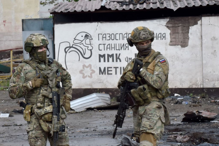 Russian servicemen stand guard at the destroyed part of the Ilyich Iron and Steel Works in Ukraine's port city of Mariupol