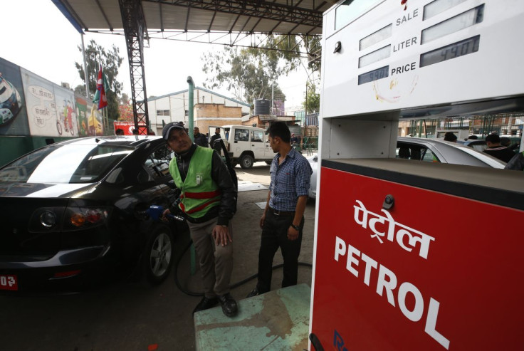 A petrol pump attendant (L) fills petrol on a car at Saja Petrol pump in Kathmandu, Nepal, January 27, 2016.