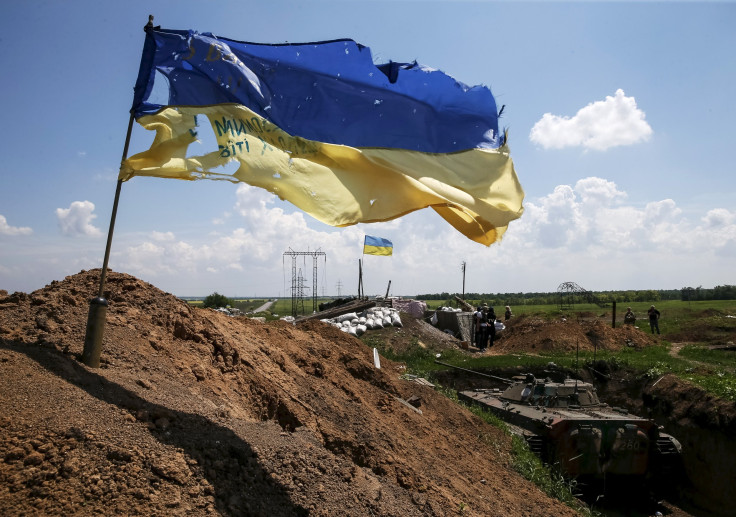 A tattered Ukrainian national flag flutters in the wind at a position held by the Ukrainian armed forces near the town of Maryinka, eastern Ukraine, June 5, 2015. Russian-backed rebels in eastern Ukraine and troops loyal to Kiev have observed an uneasy ce