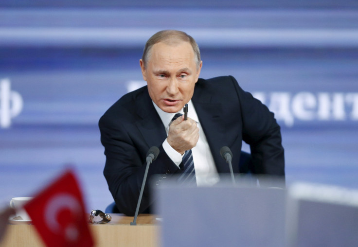 Russian President Vladimir Putin speaks in Moscow during his annual end-of-year news conference, with a flag of Turkey seen in the foreground Dec. 17, 2015.