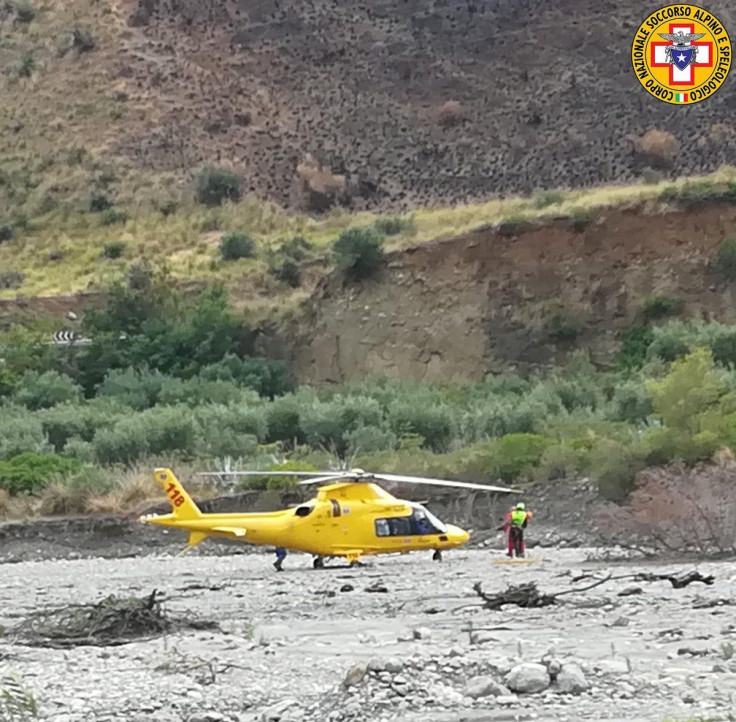 A rescue helicopter is seen after several people were killed in a mountain gorge flooding, in the municipality of Civita, Calabria, Italy, Aug. 20, 2018.