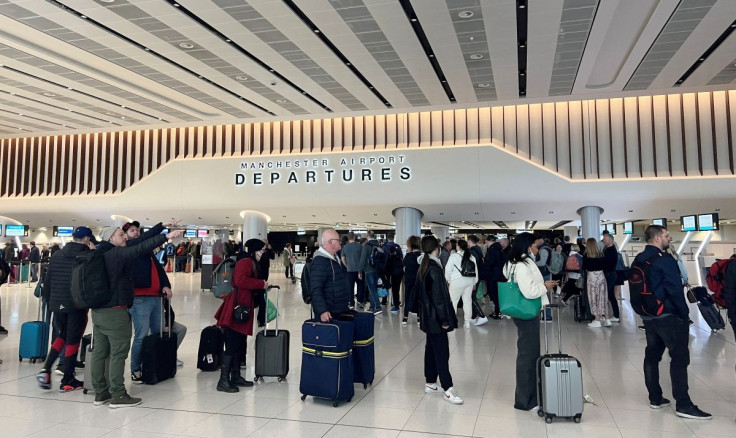 Passengers queue for security screening in the departures area of Terminal 2 at Manchester Airport in Manchester, Britain April 4, 2022.