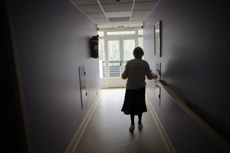 A woman, suffering from Alzheimer's desease, walks in a corridor in a retirement house in Angervilliers, eastern France, March 18, 2011.