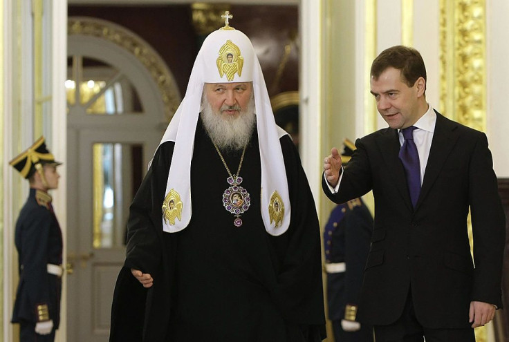 Russian Orthodox Patriach Kirill (L) walks with former Russian President Dmitry Medvedev (R) at the Kremlin in Moscow on February 2, 2009