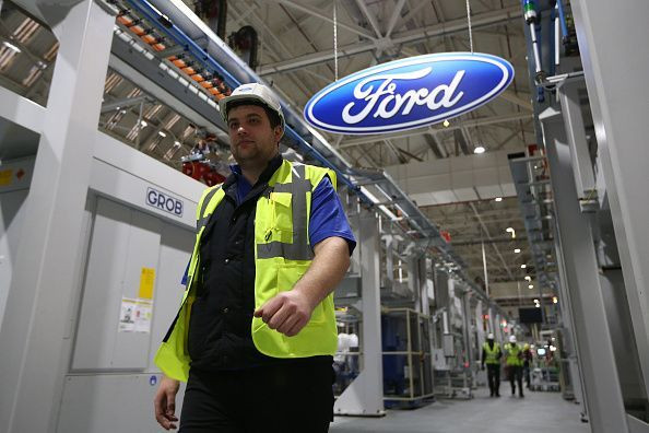 Ford will cut thousands of jobs in Europe as well as close a plant in France as part of its global restructuring plan. An employee walks past a Ford logo in the yet-to-be-completed engine production line at a Ford factory on Jan. 13, 2015 in Dagenham, Eng