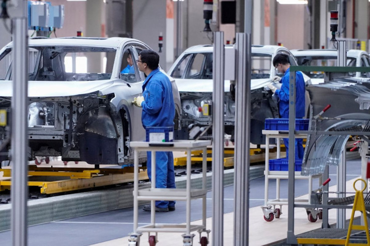 Employees work on assembly line during a construction completion event of SAIC Volkswagen MEB electric vehicle plant in Shanghai