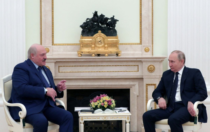 Russian President Vladimir Putin listens to Belarusian President Alexander Lukashenko during a meeting at the Kremlin in Moscow, Russia March 11, 2022. Sputnik/Mikhail Klimentyev/Kremlin via REUTERS