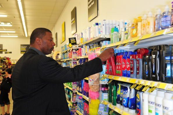 Former New York Giants linebacker Carl Banks shops Procter and Gamble products during the official opening of the Saddle Brook Dollar General Store in Saddle Brook, New Jersey, Sept. 12, 2009.