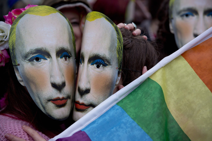 Protesters wearing masks of Russia's President Vladimir Putin pretend to kiss as they take part in a demonstration against the country's "anti-gay" laws outside the Embassy of the Russian Federation in London, Feb. 14, 2014.