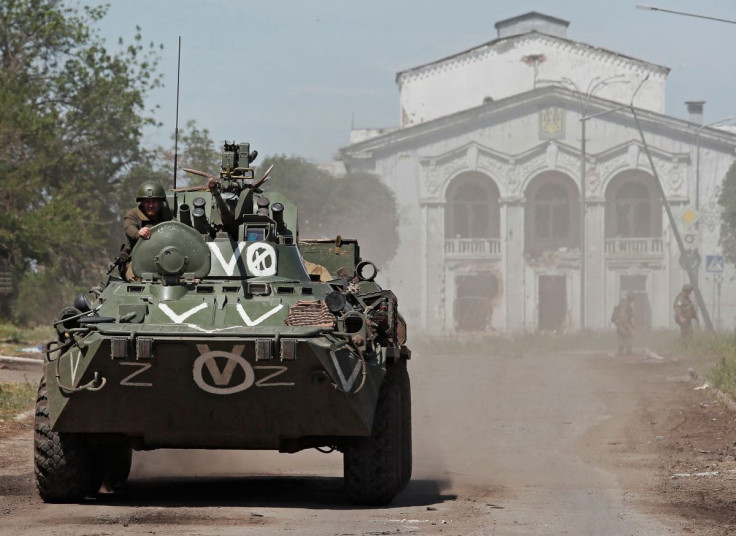 A service member of pro-Russian troops rides on top of an armoured personnel carrier during Ukraine-Russia conflict in the town of Popasna in the Luhansk Region, Ukraine June 2, 2022.