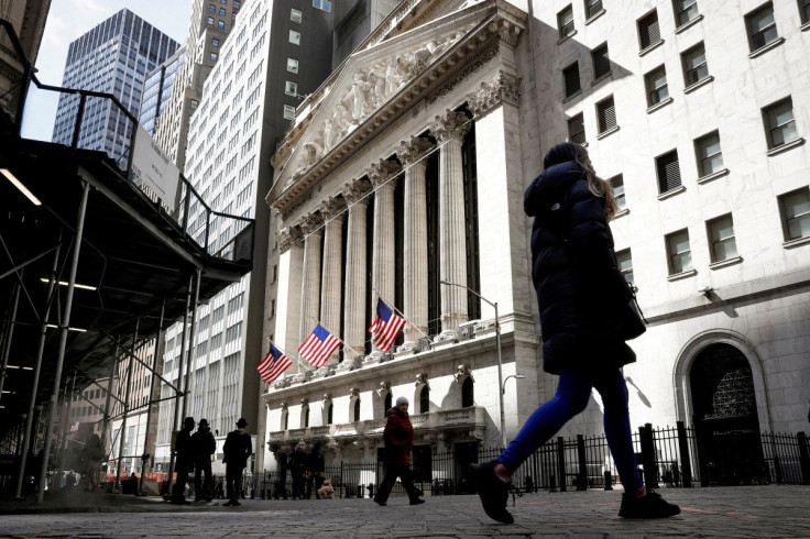 People are seen on Wall Street outside the NYSE in New York