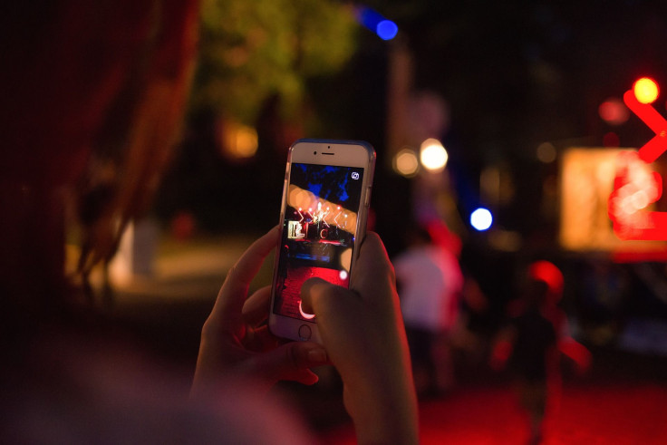 Representation. A person using the camera on their smartphone.