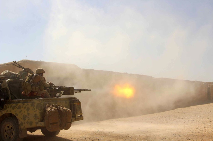 In this photograph taken on Oct. 9, 2016, Afghan National Army commandos open fire on a Taliban position during a military operation in Helmand province.