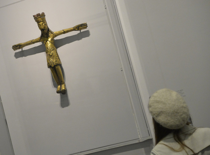 A 1,100-year-old pendent predates when Christianity was thought to have spread in Denmark. Above, a visitor views a different, twelfth century Danish copper crucifix at the British Museum in London March 4, 2014.