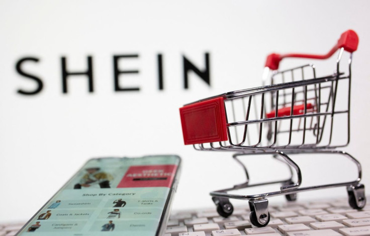 A keyboard and a shopping cart are seen in front of a displayed Shein logo in this illustration picture taken October 13, 2020.