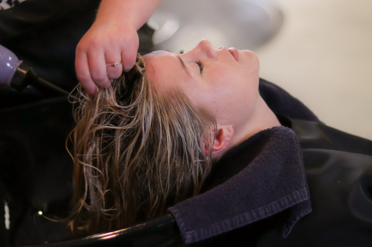 Representation. A woman getting her hair washed at a salon.
