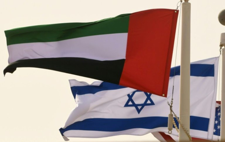 In his file photo taken on August 31, 2020, the Emirati, Israeli and US flags fly at the Abu Dhabi airport at the arrival of the first-ever commercial flight from Israel to the UAE