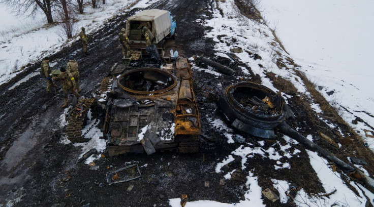 Ukrainian servicemen inspect a charred Russian tank, amid Russia's invasion of Ukraine, in the Sumy region, Ukraine, March 7, 2022. Picture taken March 7, 2022. Irina Rybakova/Press service of the Ukrainian Ground Forces/Handout via REUTERS