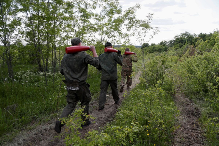Service members of pro-Russian troops carry leaflet shells at their combat positions in the Luhansk region, Ukraine May 24, 2022.