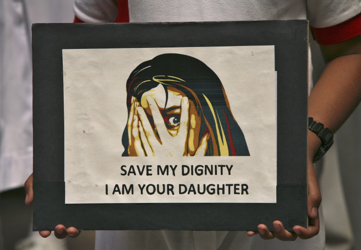 A schoolgirl holds a placard during a prayer meeting for a five-year-old rape victim in Jammu April 20, 2013.