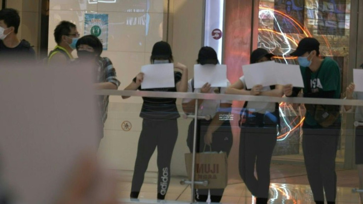 As the sweeping national security law sends a wave of fear through Hong Kong and outlaws popular protest slogans, protesters replace flags and placards with blank sheets of white paper to continue voicing dissent