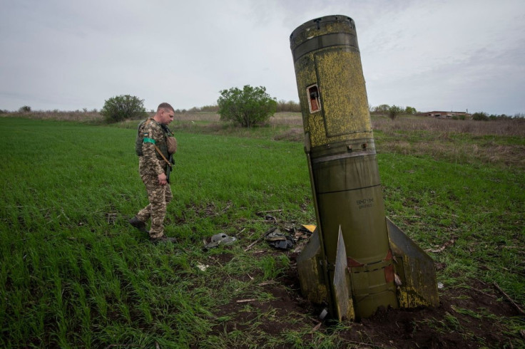A Ukrainian serviceman walks next to remains of a Russian Tochka U ballistic missile, as Russia's attack on Ukraine continues, in Kharkiv region, Ukraine, in this handout picture released April 23, 2022. Press service of the Ukrainian Ground Forces/Hando