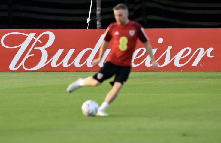 A player of the Wales team is backdropped by a billboard of beer sponsor Budweiser as he takes part in a training session at the Al Saad SC in Doha on Nov. 19, 2022, ahead of the Qatar 2022 World Cup. Qatar and FIFA announced a stadium ban on beer sales o